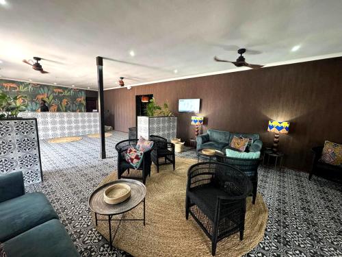 a living room with couches and chairs at Elephant Springs in Bela-Bela