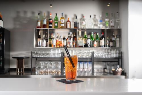 a drink sitting on a counter in a bar at Hotel Mercure Milano Solari in Milan
