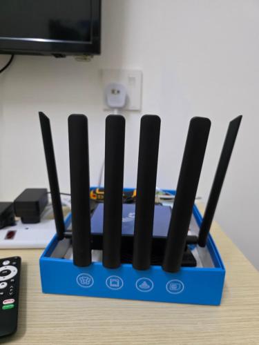 a blue holder with severalsticks in it on a table at Aqimi Homestay in Seri Iskandar