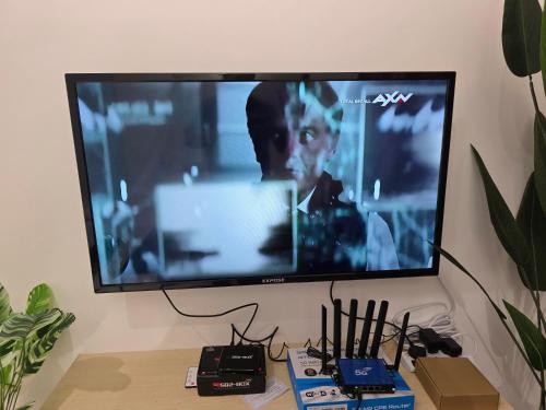a flat screen tv hanging on a wall at Aqimi Homestay in Seri Iskandar