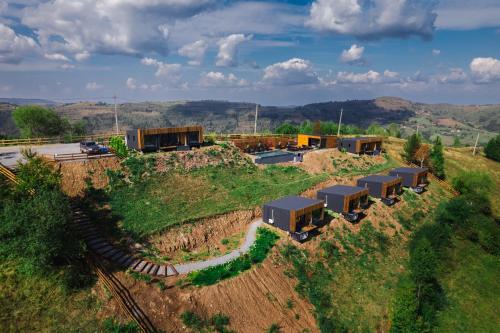 an overhead view of a train yard with containers at The Altitude Cabin Resort in Măguri