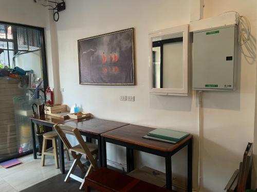 a kitchen with a wooden table and a window at M3 Bangkok Bake & Bed in Bangkok