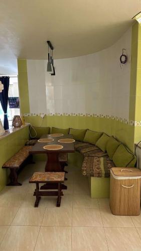 a room with a couch and a table and benches at Dar El Bhar, villa sul mare in Kelibia
