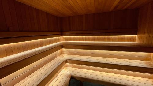 an empty sauna with wood paneling and lights at Vinni Sport & Spa hostel in Vinni