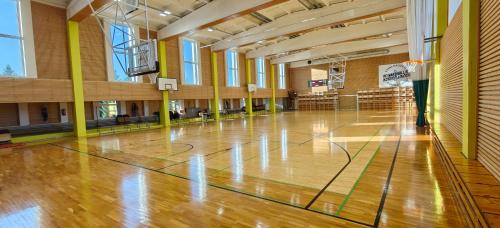 an empty gym with a basketball court in a building at Vinni Sport & Spa hostel in Vinni