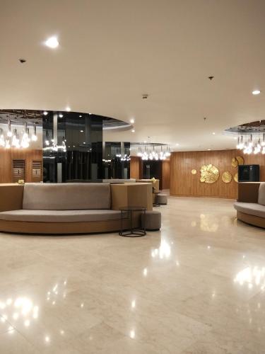 a lobby with couches and tables in a building at Shore2 tower2 in Manila