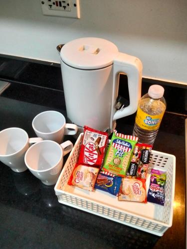 a basket of snacks and a coffee maker on a counter at Shore2 tower2 in Manila