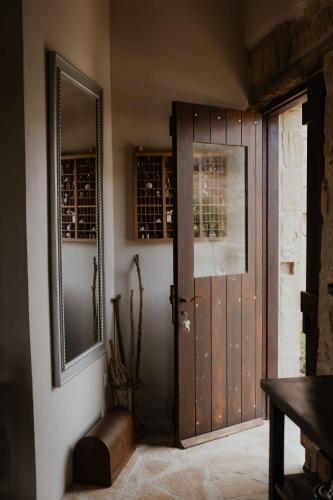a room with a door with a mirror and a table at Ewas Cretan Vintage Houses- Pet Friendly in Kharkhalianá