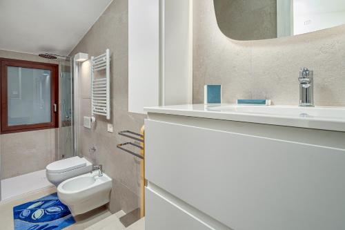 Ginepro Apartment - by And service في Casa Tamponi: حمام مع مرحاض ومغسلة