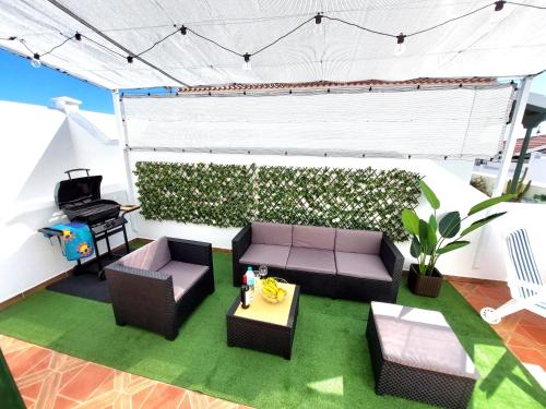 a living room with a couch and chairs and a piano at Mucha Vida in Abades