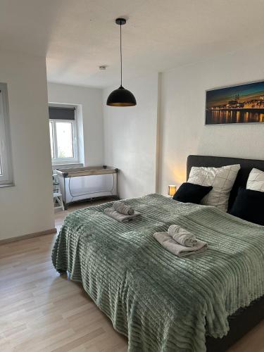 a bedroom with a bed with a green blanket at Yellow one in Magdeburg