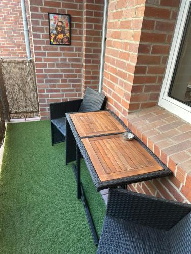a wooden table and chairs on a patio at Yellow one in Magdeburg