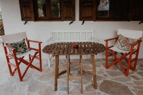 two chairs and a table and a table and chairs at Ewas Cretan Vintage Houses- Pet Friendly in Kharkhalianá