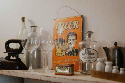 a shelf with wine glasses and a can of beer at Ewas Cretan Vintage Houses- Pet Friendly in Kharkhalianá