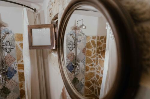 a mirror on a wall in a room at Ewas Cretan Vintage Houses- Pet Friendly in Kharkhalianá