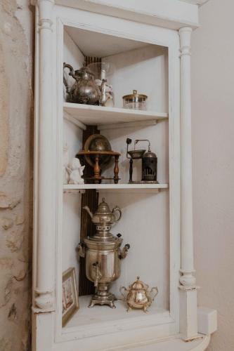 a white shelf with various items on it at Ewas Cretan Vintage Houses- Pet Friendly in Kharkhalianá