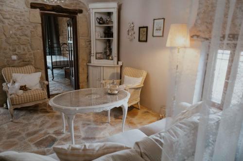 a living room with a table and a couch at Ewas Cretan Vintage Houses- Pet Friendly in Kharkhalianá