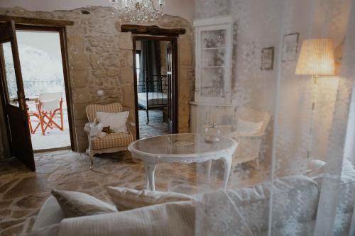 a living room with a table and chairs at Ewas Cretan Vintage Houses- Pet Friendly in Kharkhalianá