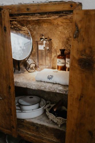 a wooden shelf with a mirror and some pots and pans at Ewas Cretan Vintage Houses- Pet Friendly in Kharkhalianá