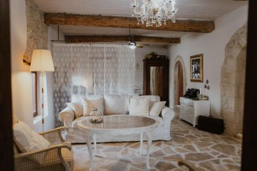 a living room with a couch and a table at Ewas Cretan Vintage Houses- Pet Friendly in Kharkhalianá