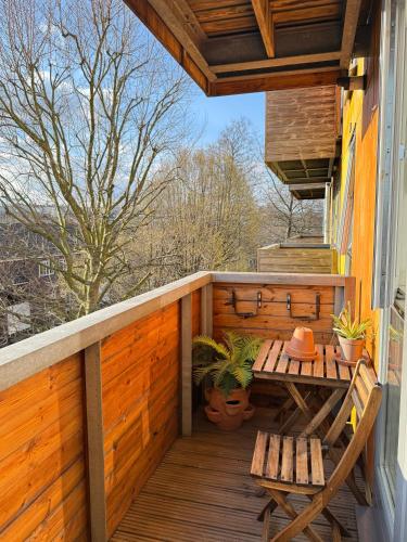 a deck with a table and benches on a house at Lombok Apartment near Old Street,Islington,Angel in London