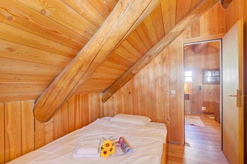 a bedroom with a bed in a wooden attic at Rustico Al Museo Bosco Gurin - Happy Rentals in Bosco Gurin