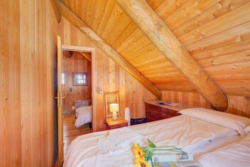 a bedroom with a bed in a wooden cabin at Rustico Al Museo Bosco Gurin - Happy Rentals in Bosco Gurin