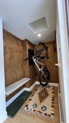 a bike hanging on the wall in a room at BÕSKI - Refuge de luxe in Stoneham