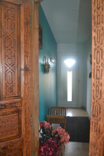 - une chambre avec une porte en bois et des fleurs dans l'établissement MAISON BERTINEAU proche Saint-Emilion, à Néac