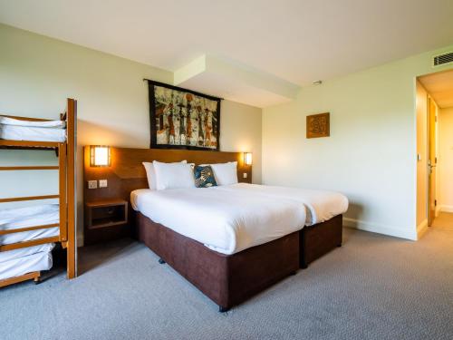 a hotel room with a large bed and a ladder at Chessington Resort Hotel in Chessington