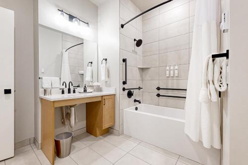 a white bathroom with a tub and a sink at 304 - Black Rock Mountain Resort in Heber City