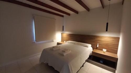 a bedroom with a bed with two towels on it at HOME UNO ESPE a 2 cuadras de peatonal in Resistencia