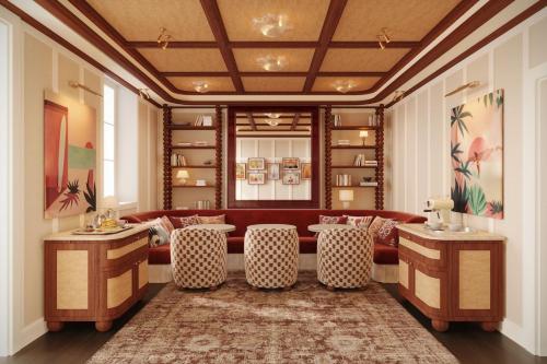 a living room with a red couch and chairs at Hotel de Silhouette in Biarritz