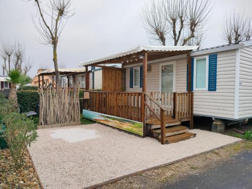 domek z werandą i ogrodzeniem w obiekcie Mobil-home Les Locs Danous w mieście Valras-Plage