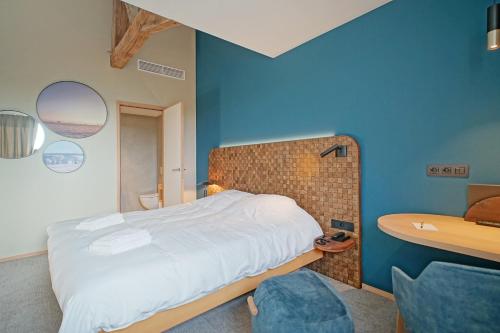 a bedroom with a bed and a bathroom with a sink at Domaine de l'Ambassadeur in Léglise