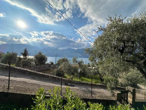 a fence with a view of the water and mountains at appartamento 2 Colombere in Malcesine