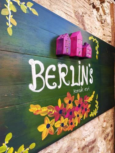 a sign that says berlins with flowers on it at Berlin's Guest House in Urla