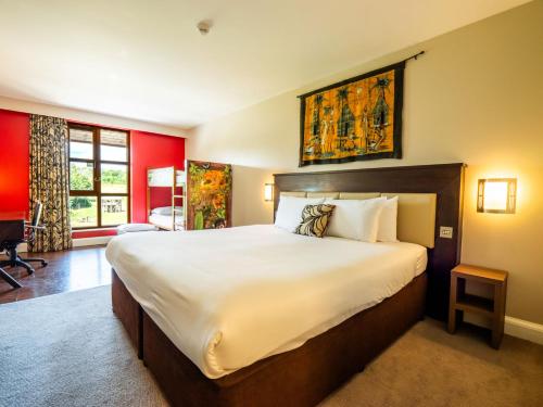 a bedroom with a large bed in a room at Chessington Resort Hotel in Chessington