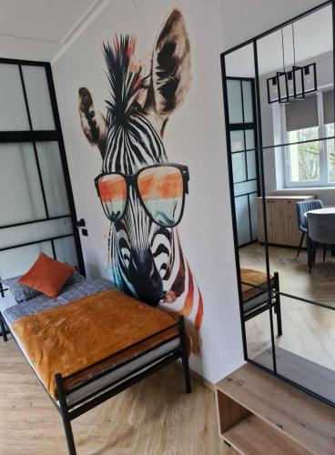 a room with a zebra mask on the wall at Szkolne Schronisko Mlodziezowe w Olsztynie in Olsztyn