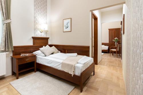 sypialnia z łóżkiem, stołem i lustrem w obiekcie Hotel Kardosfa w mieście Zselickisfalud