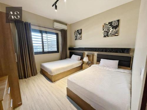 Katil atau katil-katil dalam bilik di Alshemy Serviced Apartments