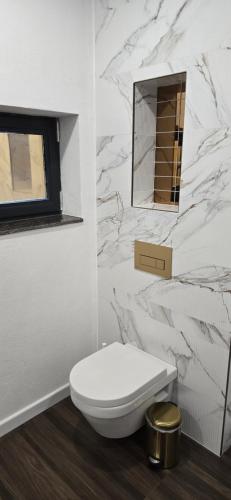 a white bathroom with a toilet and a mirror at Inspire View - Boutique in Bran