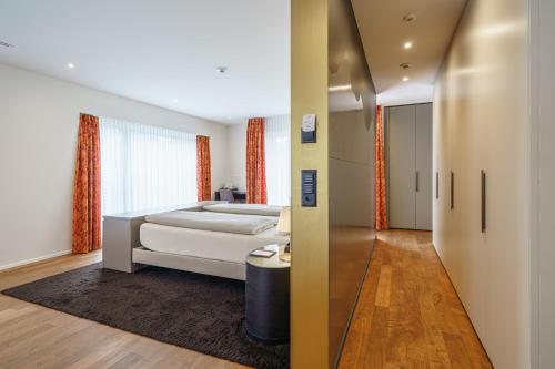 a bedroom with a bed and a hallway at Hotel Du Nord in Interlaken