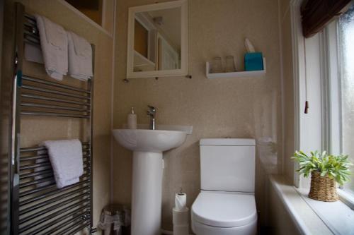 a bathroom with a toilet and a sink at The Kings Arms in Stafford