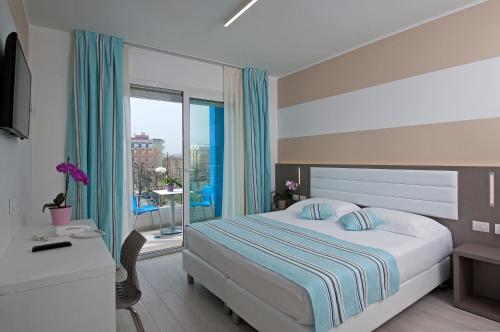 a bedroom with a bed and a window with a view at Lungomare Relax Residence in Misano Adriatico