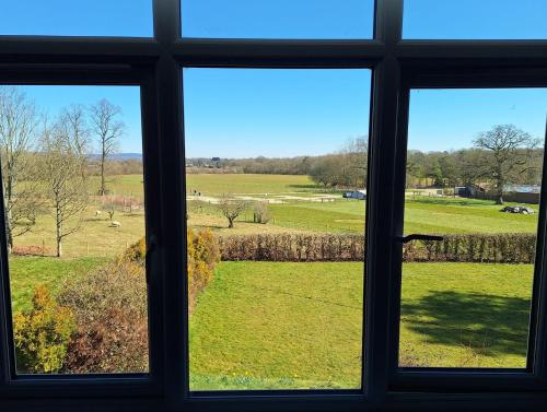 a view of a field from a window at Spacious Double Room with Lovely Views in Cranleigh