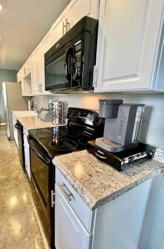 a kitchen with a stove and a microwave at Posh Pad in Marion