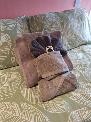 a pair of towels sitting on a bed at Comfortable Double Room with Bath in Cranleigh