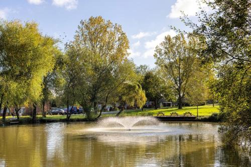 a fountain in a pond in a park at Comfortable Double Room with Bath in Cranleigh