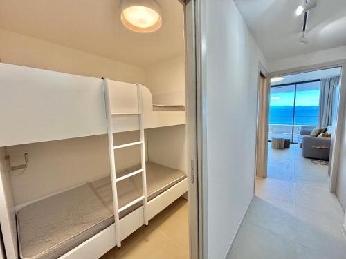 a room with bunk beds and a view of the ocean at Appartement Eden A sanguinaires vue mer avec piscine résidence in Ajaccio